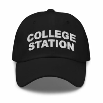 Person wearing the College Station Texas Hat outdoors