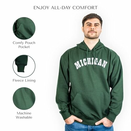 Man wearing green Michigan hoodie with features: comfy pouch pocket, fleece lining, machine washable.