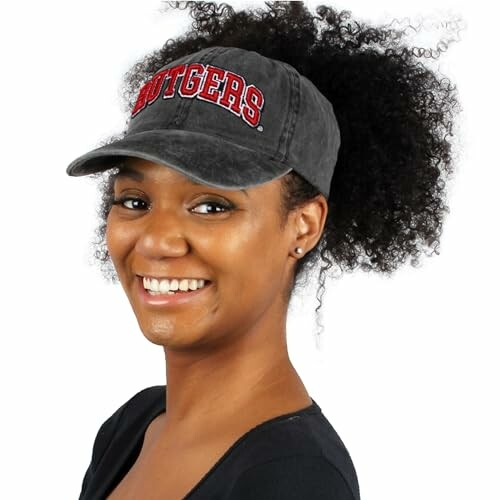 Smiling woman wearing a Rutgers cap.